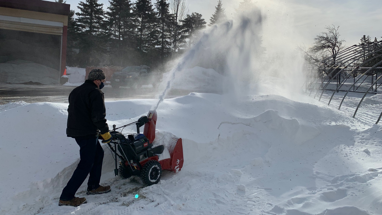 Operator runs snow blower on the Kirby Terrace
