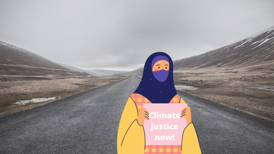 Climate justice now protestor art over an empty road