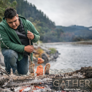 Man cooking fish on a fire from the movie Gather